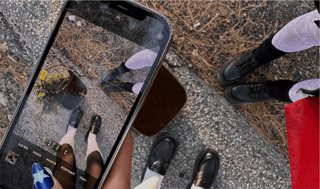 A group of young women taking a picture with their iPhone